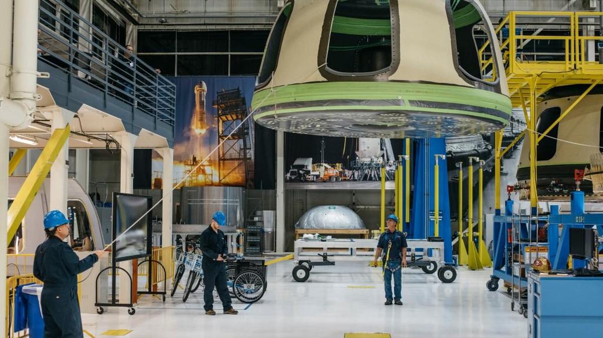 Blue Origin team members ready the New Shepard Crew Capsule during assembly.