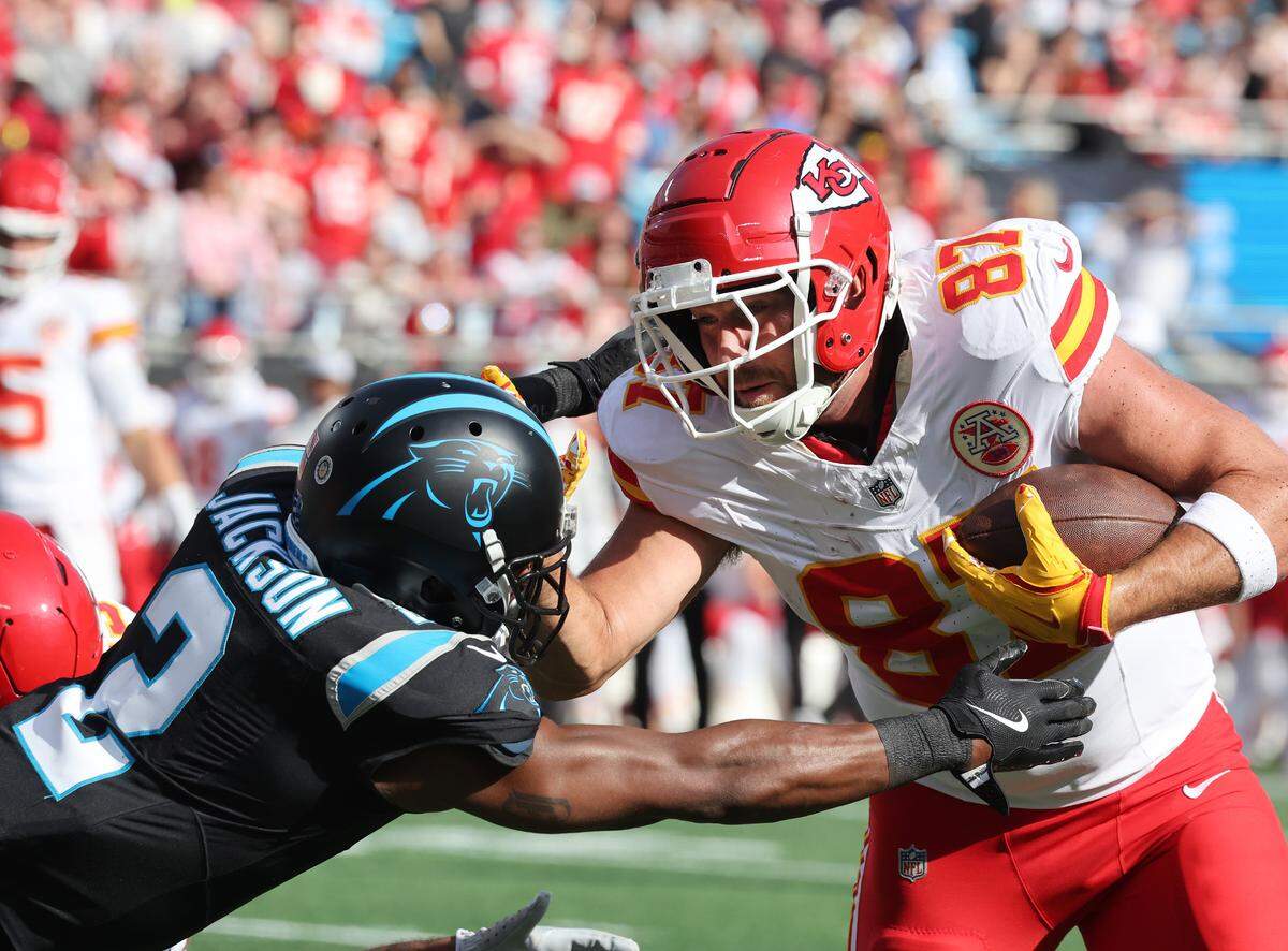 Chiefs tight end Travis Kelce attempts to hold off Panthers Mike Jackson Sunday in Charlotte, N.C.