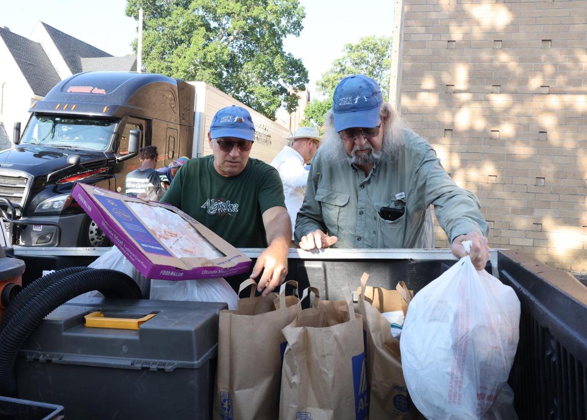 Bill Sliney, left, and Gregg Prange load groceries into a truck Monday, July 21, 2025 in Rock Hill, S.C.