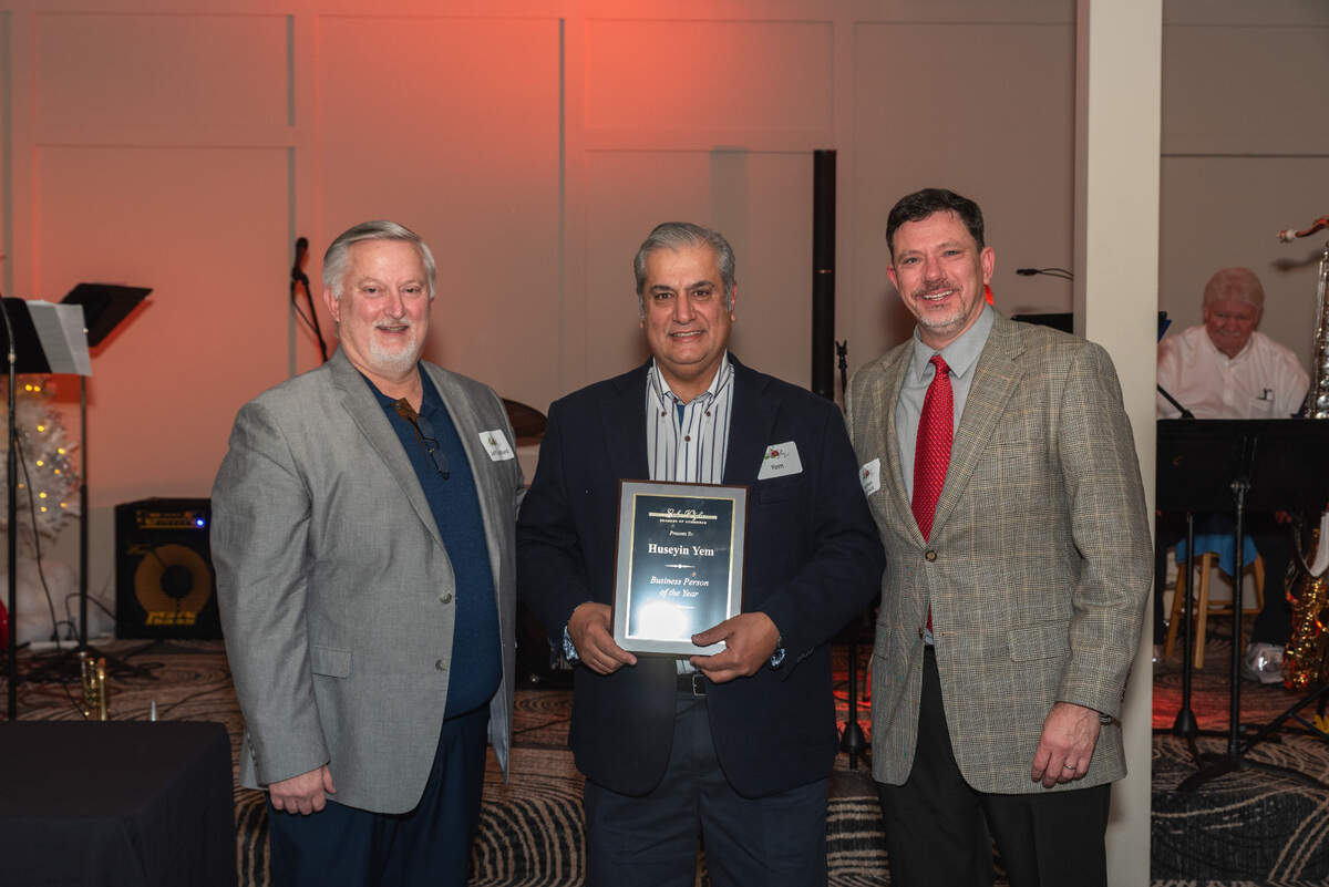 Lake Wylie Pizza & Italian Restaurant owner Huseyin Yem, center, was named 2023 business person of the year by the Lake Wylie Chamber of Commerce.
