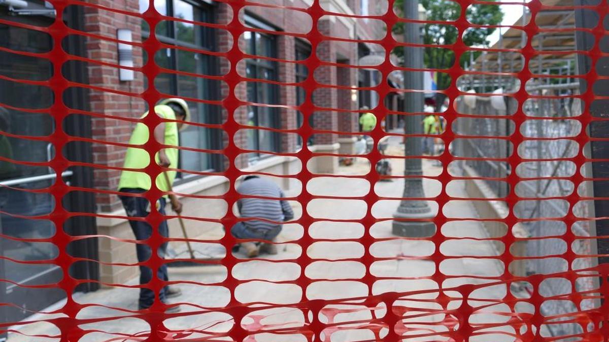 Workers putting the finishing touches on Rock Hill’s 139 Main Street apartment building, behind a closed section of the East Main Street sidewalk. New developments such as the apartments are being touted as representing the growth of the Knowledge Park area.