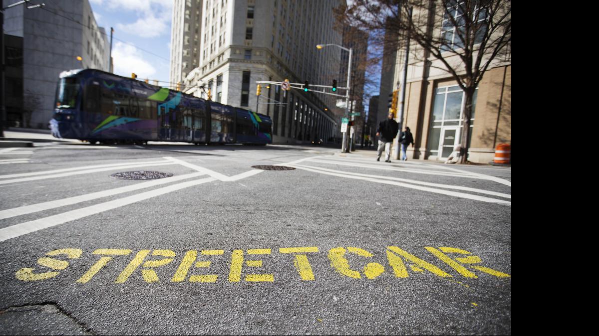 
An Atlanta streetcar passes a sign on the street warning pedestrians in a crosswalk as it makes its inaugural trip through downtown on Dec. 30, 2014. The streetcar's 2.7-mile route connects neighbors to several tourist attractions, museums and entertainment venues.

