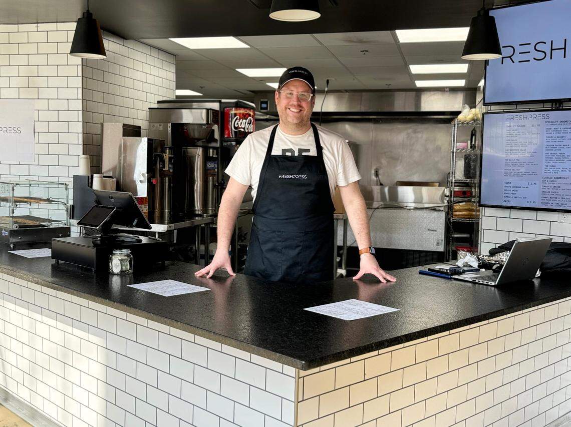 Kevan Cohn, owner of FRESHPRESS sandwich shop, stands in his booth Wednesday at the Power House in Rock Hill.