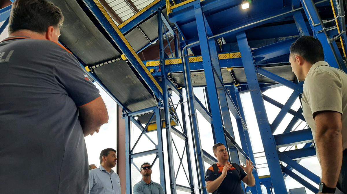 Valerio Bartolotti, back right, with Italian metal company Danieli, explains the inner workings of a new auto and metal shredder in Rock Hill.