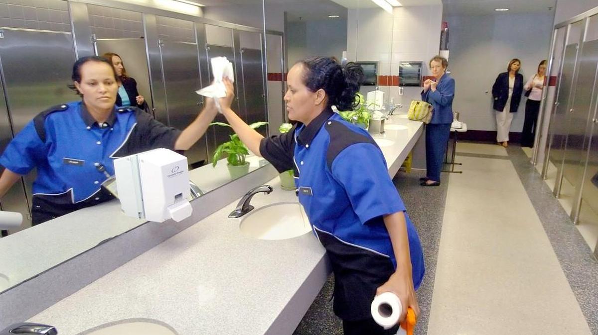 A restroom attendant cleans her assigned area at Charlotte Douglas International Airport.