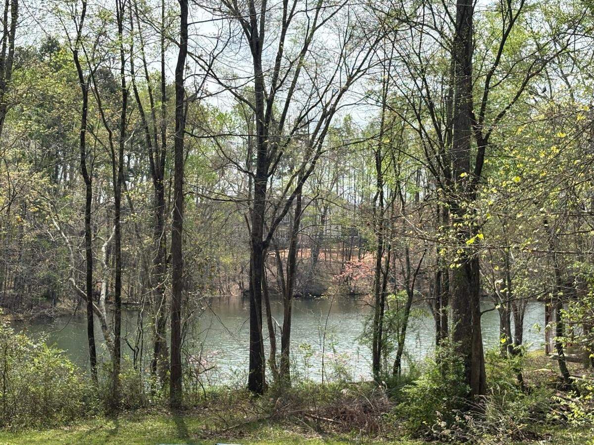 Nims Lake, largely wooded around the outside and on private property, was once a popular community swimming hole in Fort Mill. Development is proposed on Nims Lake Road, not far from the site.