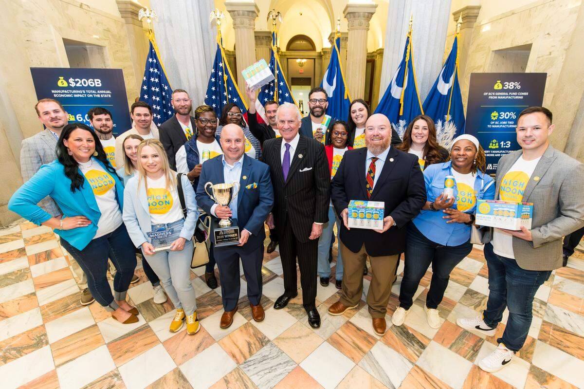 Gov. Henry McMaster, center, presents the trophy on Wednesday to the Gallo Winery group in Chester County after its High Noon product won the title of coolest item produced in South Carolina.