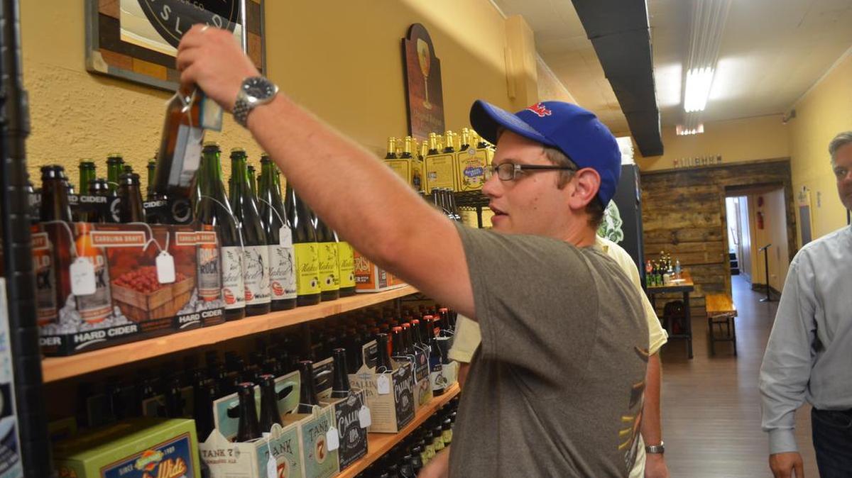
Tom Efthimiades, a recent transplant from Boston to Rock Hill, selects his own six-pack at the Main St. Bottle Shop recently. The store encourages people to try new beers, creating their own one-of-a-kind six-pack to expand their beer palates. 
