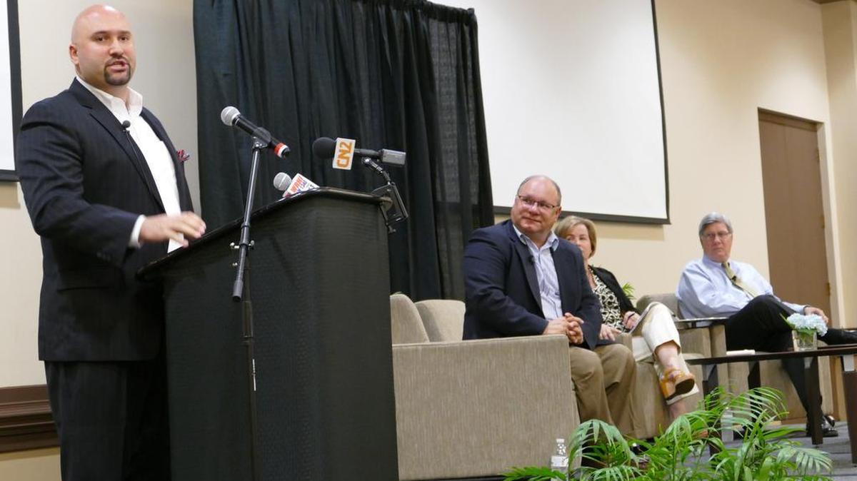 Jonathan Ferguson, the COO of Rock Hill-based software company Cimplx, speaks at the York County Regional Chamber of Commerce breakfast. Seated to Ferguson’s left are developer Tim Elliott, Rock Hill downtown manager Cathy Murphy, and Mayor Doug Echols.
