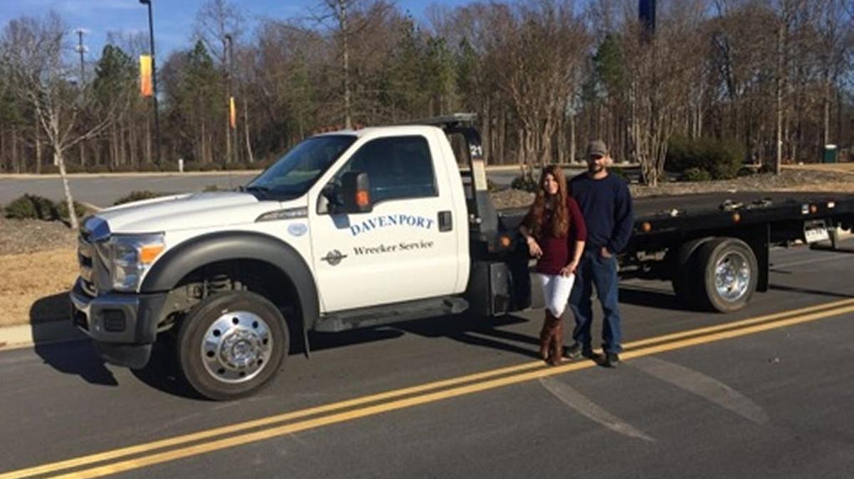 Kenny and Brittany Davenport pose near a Davenport Auto Repair and Collision Center truck.