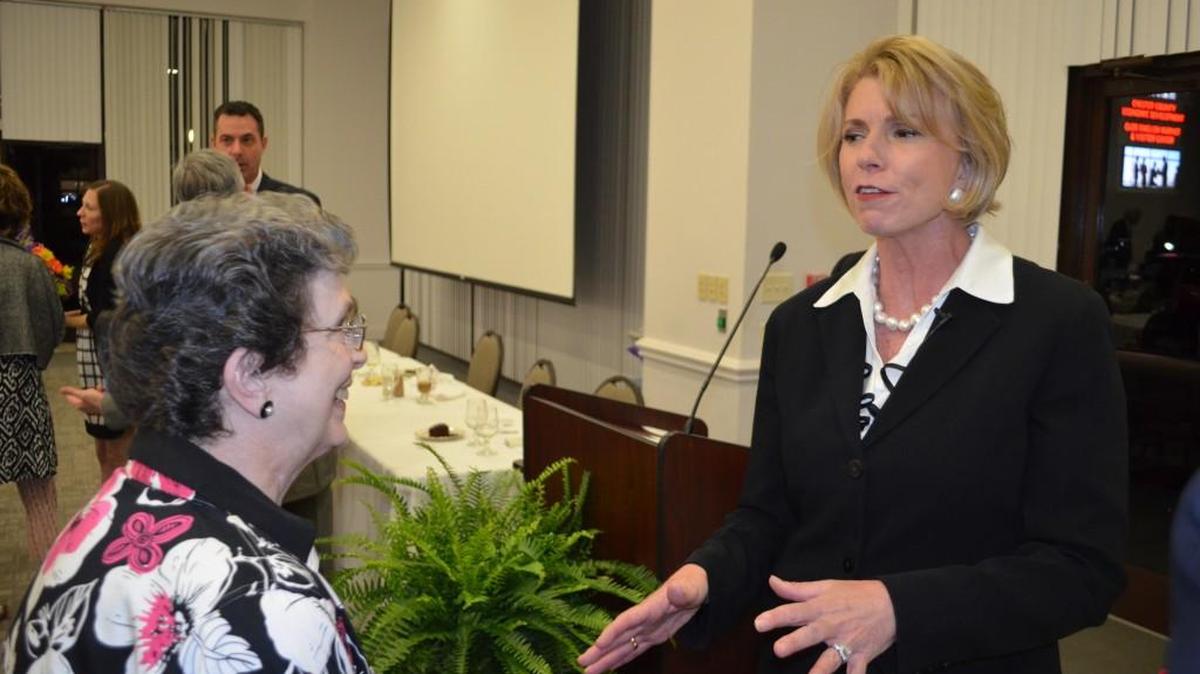 Pamela Eyring, right, president of The Protocol School of Washington, talks with members of the Chester County Chamber of Commerce following its annual meeting.