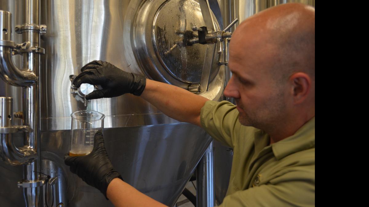 
Mike Krail, brewmaster at the Legal Remedy Brewery on Oakland Avenue, pour a sample of a pale ale for testing recently. 
