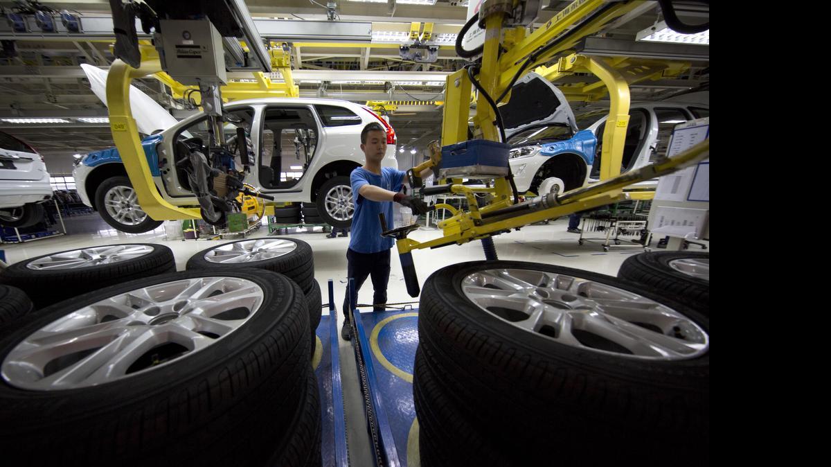
 A worker installs wheels on a car at a Volvo factory in Chengdu in southwestern China's Sichuan province. The Swedish company will export these cars to the United States from this plant as well as make Volvo at its planned new plant in South Carolina. 
