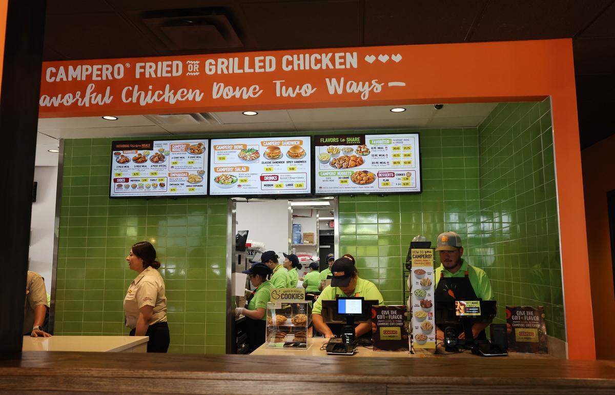 Employees work in the kitchen and at the register at Pollo Campero in Rock Hill on Tuesday. The restaurant serves a variety of chicken dishes.