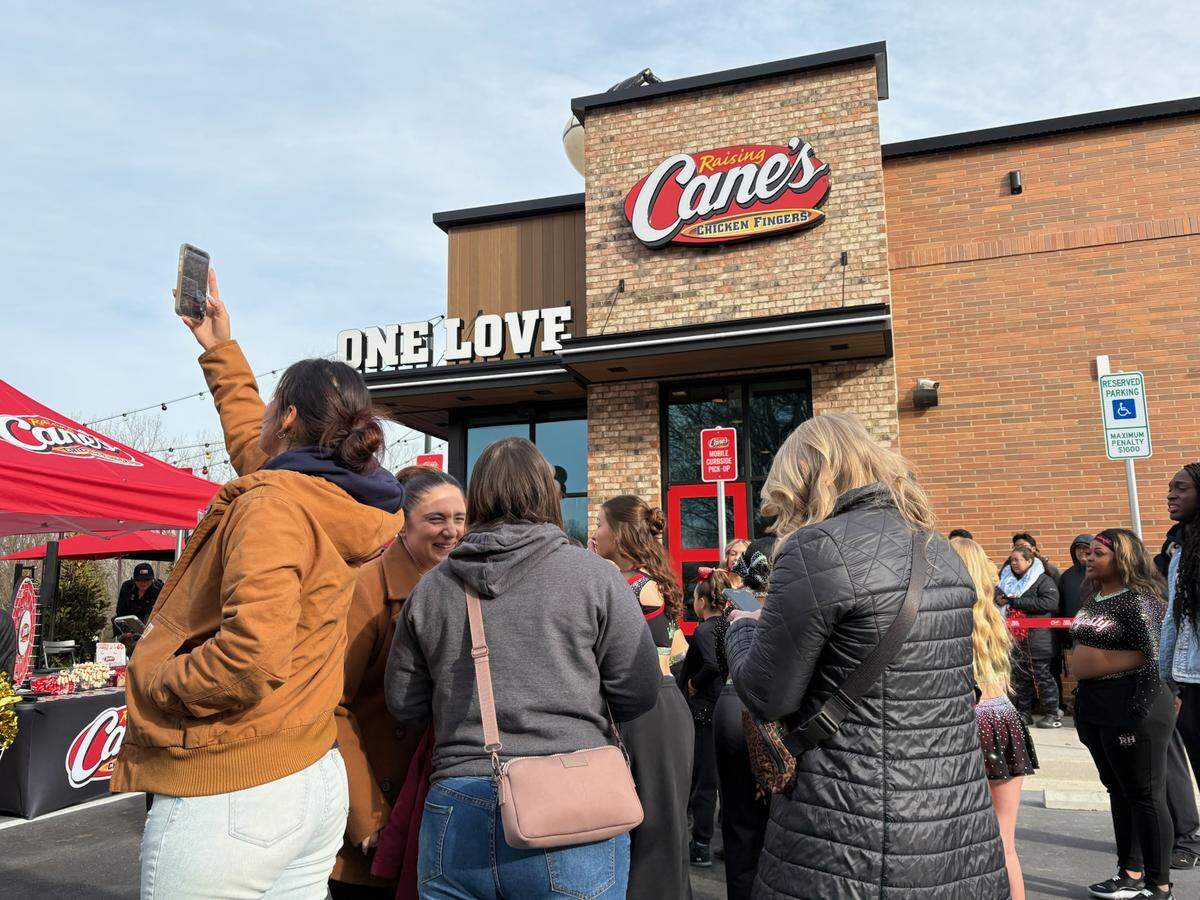Visitors wait for the opening of Raising Cane’s in Rock Hill on Tuesday morning.