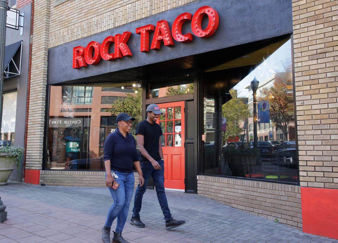 Pedestrians walk by Rock Taco on Main Street in Rock Hill on Monday.