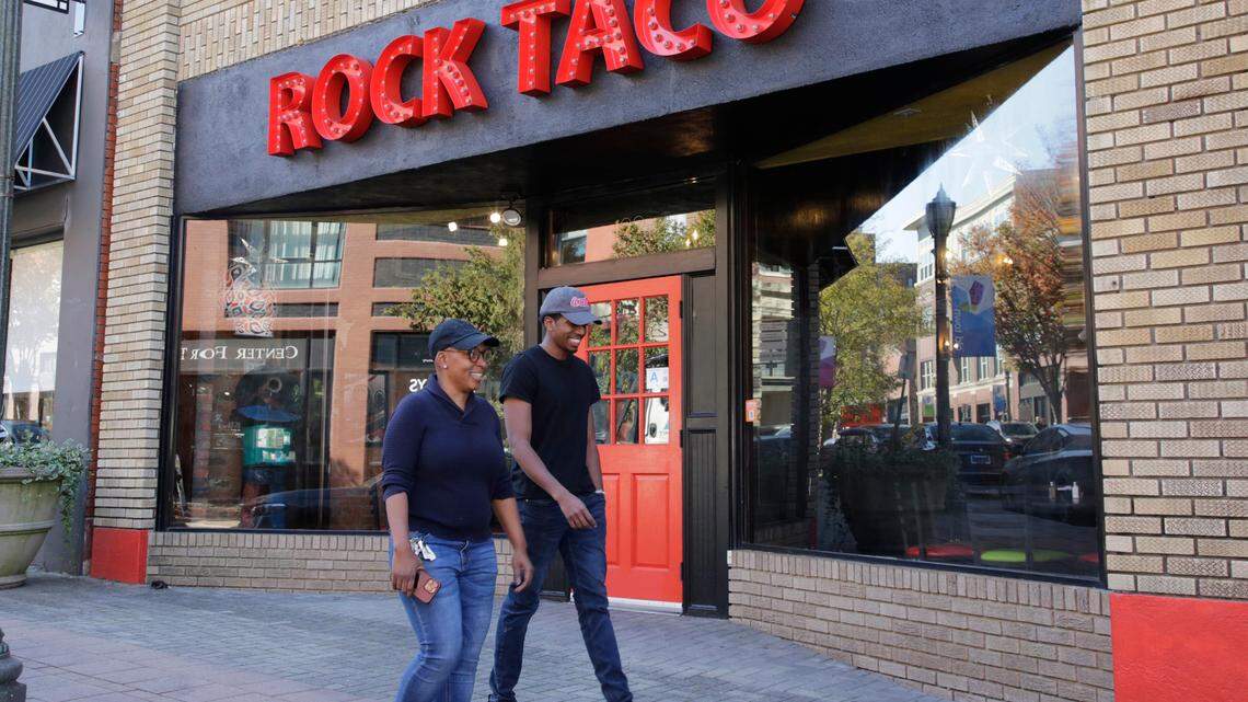 Pedestrians walk by Rock Taco on Main Street in Rock Hill on Monday.