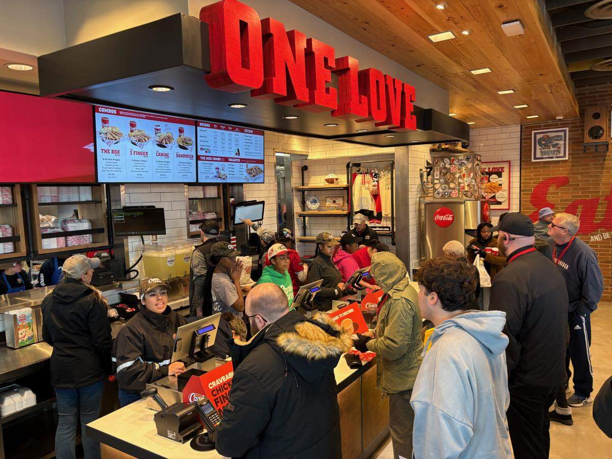 Customers place orders on Tuesday just after the grand opening at Raising Cane’s, a chicken tender restaurant off Dave Lyle Boulevard in Rock Hill.