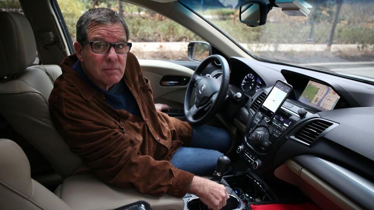 Jim Butler drives for the car service Uber and also for UberEats, which delivers meals to customers in Chicago. (Terrence Antonio James/Chicago Tribune/TNS)
