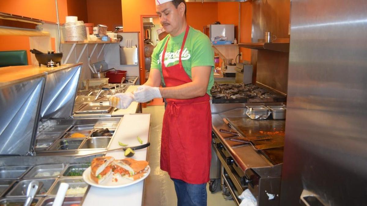 Javier Abaez finishes making a chorizo tortas at El Molcajete on Mount Gallant Road. The chorizo sausage is handmade.
