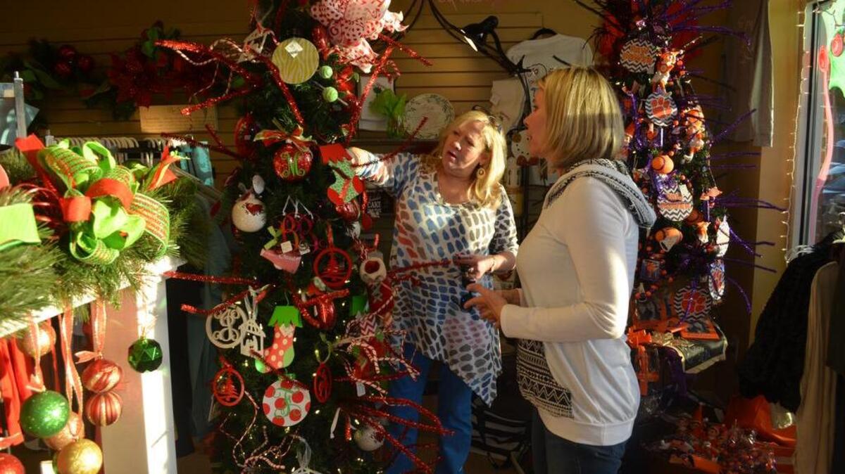 Brenda Hallman, right, helps Beth Simpson look for ornaments during a recent trip to Two Social Butterflies in Rock Hill. Hallman says she likes to shop local, but will be one of the many shoppers nationwide that will likely not shop Thanksgiving or Black Friday.