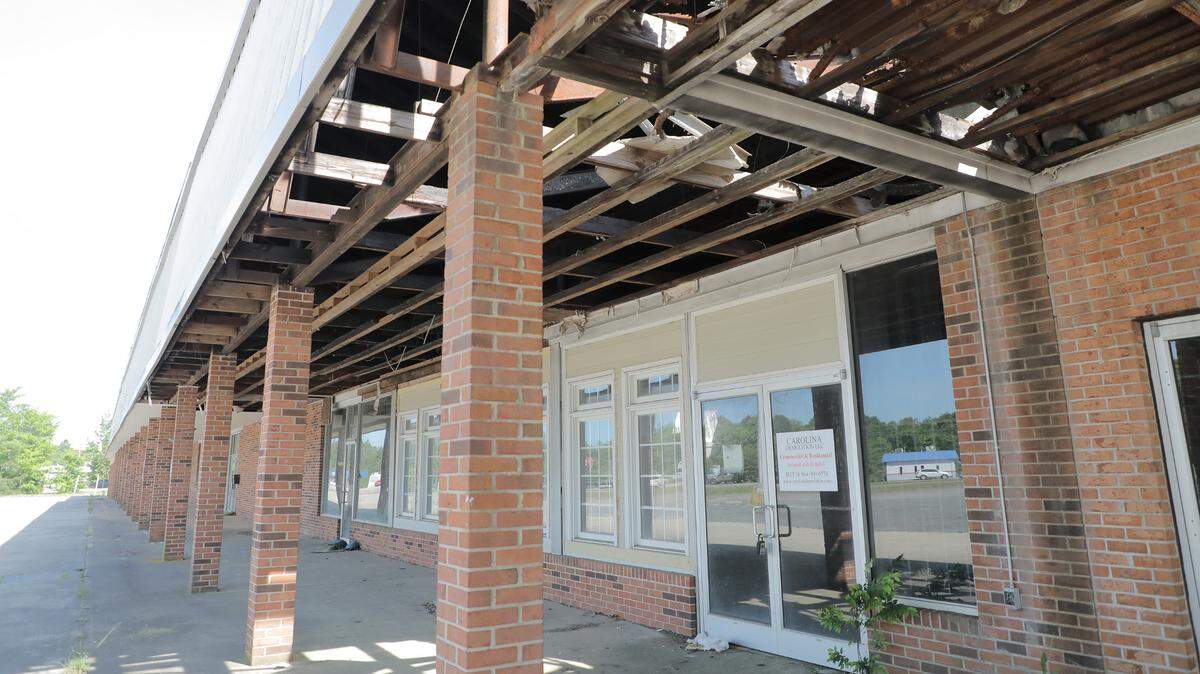 The roof of a dilapidated shopping center has fallen through at the intersections of Heckle Blvd., Albright Road and Saluda Street.
