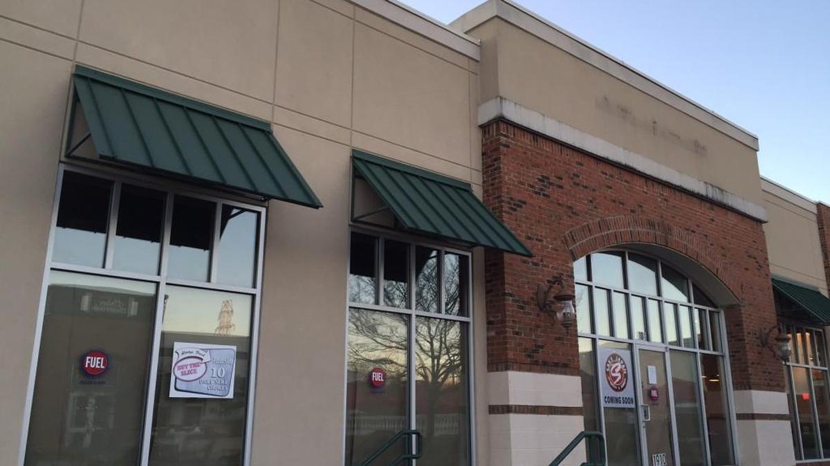 The doors and windows are covered at the site of the former Fuel Pizza Cafe at Manchester Village. A new Japanese restaurant is coming soon.