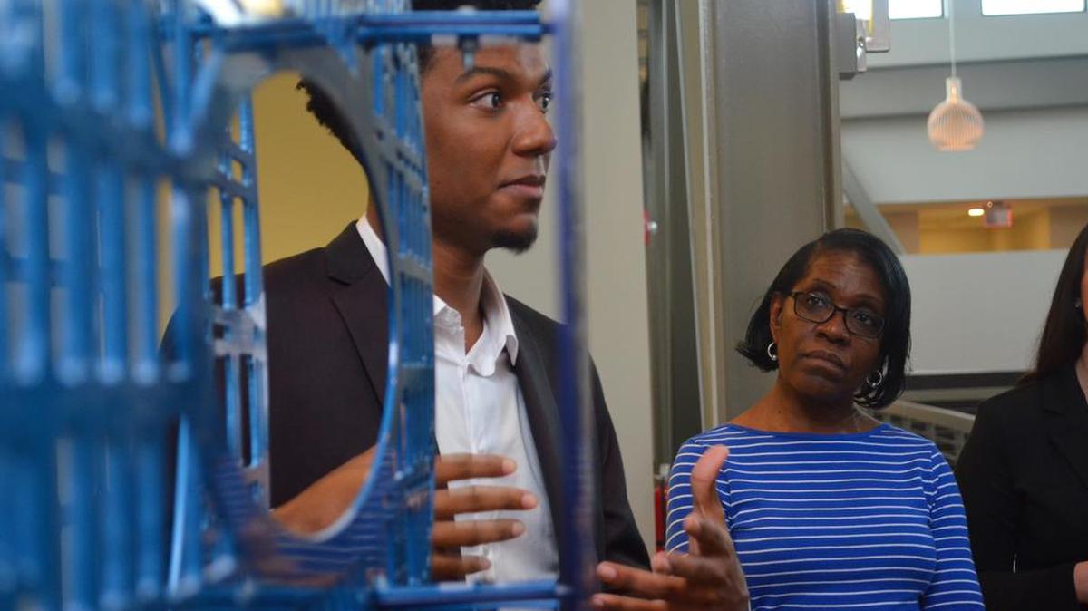 
Artist Christopher Small is framed between the layers of his work “Transitions in Blue” at the Family Trust Center in Rock Hill on Thursday.
