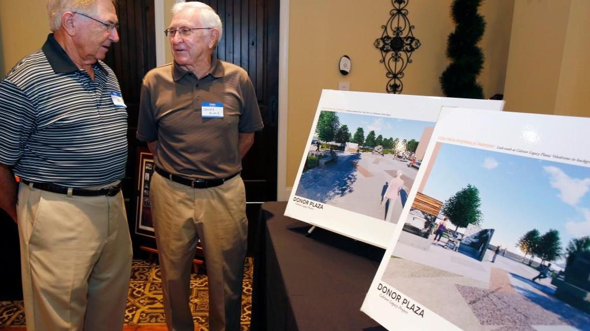 
At Wednesday’s kickoff event, former Celriver employees Hoyle Ramsey, left, and James Sims look at renderings of the donor plaza proposed for the Riverwalk development.
