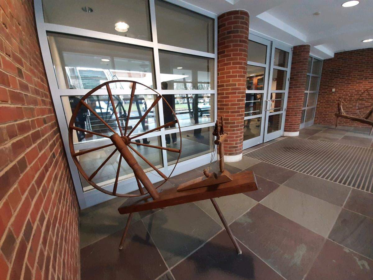 Spinning wheels sit in the entrance to the former Springs Global headquarters site on North White Street in Fort Mill.
