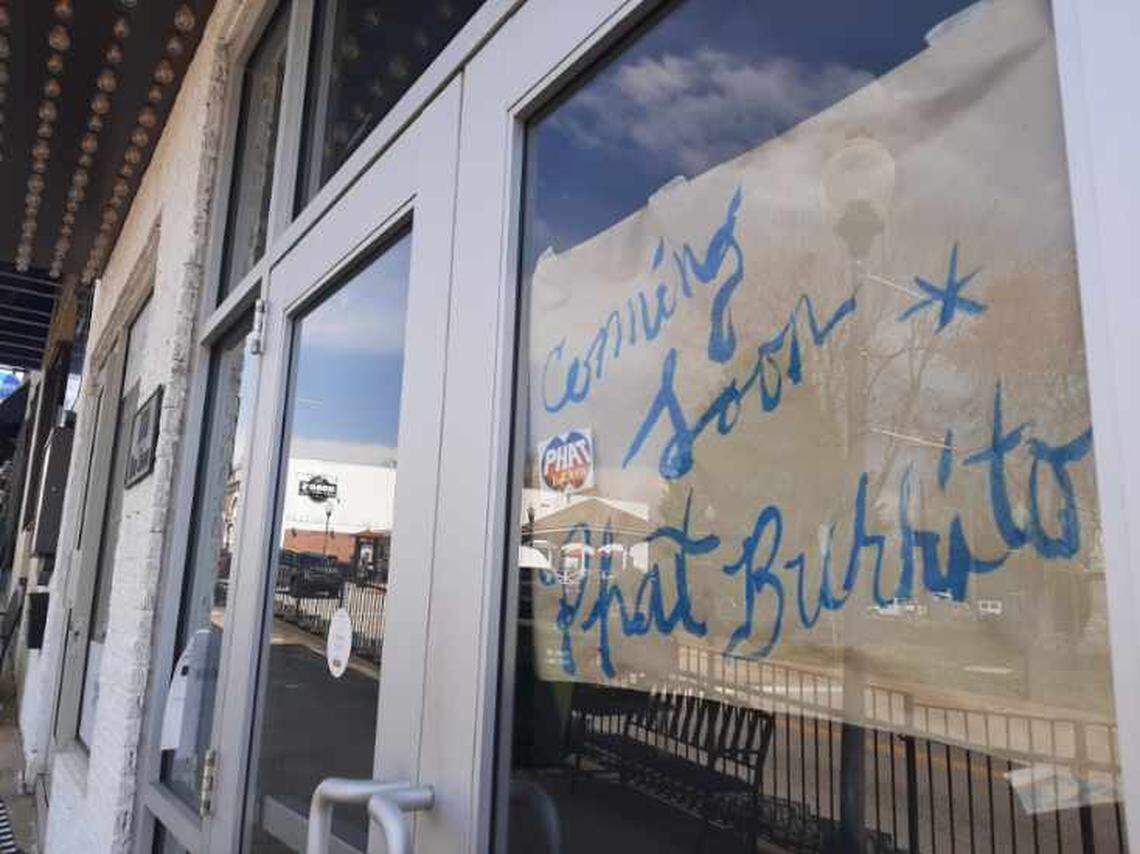 A sign in the window of the Center Theatre property at 100 Main St. promotes the coming opening of Phat Burrito, a Charlotte restaurant.