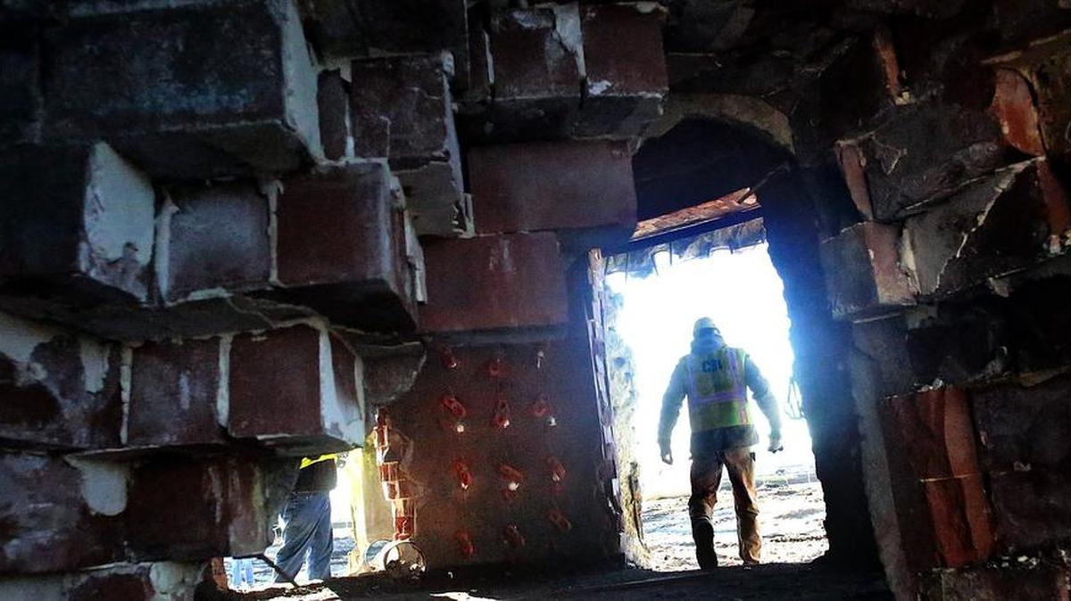 Ray Zukowski sets dynamite charges in small holes drilled at the base and inside wall of the 300-foot tall stacks at the Grainger Generation Station in Conway on Friday, Feb. 5, 2016. The stacks will be toppled at 8 a.m. Sunday. Santee Cooper officials said a series of explosions at the base of the stacks will cause the stacks to fall like trees. Zukowski is the field operations manager for Controlled Demolition Inc. The Dolphus M. Grainger Power Station was retired at the end of 2012 after 50 years of coal-fired power generating. The stacks are visible throughout Conway. The plant is located off U.S. 501 bypass near Savannah Bluff. The public is invited to watch the towers fall and plant officials suggest watching the event from the walking trail at Lake Busbee. U.S. 501 in front of the plant will be blocked to traffic for a few minutes as the stacks fall. The bypass exit ramps and a section of Marina Drive will be blocked off for a longer period on Sunday as the dust settles.