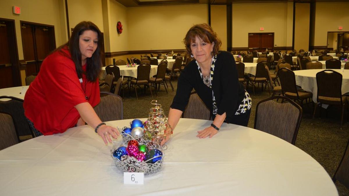 Rhonda Cauthen, left, and Mikki Rentschler adjust centerpiece prior to an event at the Hood Center at York Technical College.