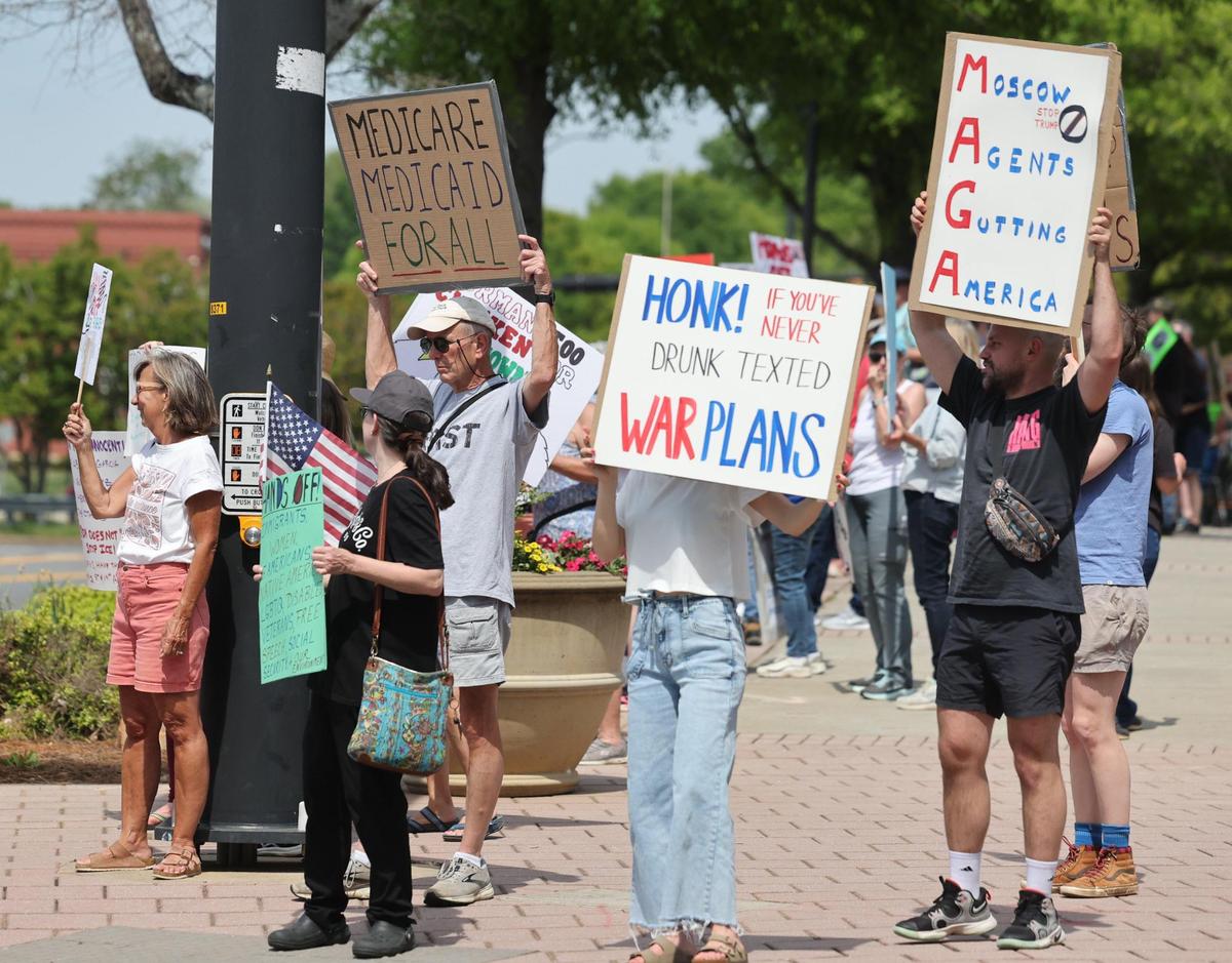 Demonstrators with York County Rising protest President Trump and his policies Sautrday in downtown Rock Hill.