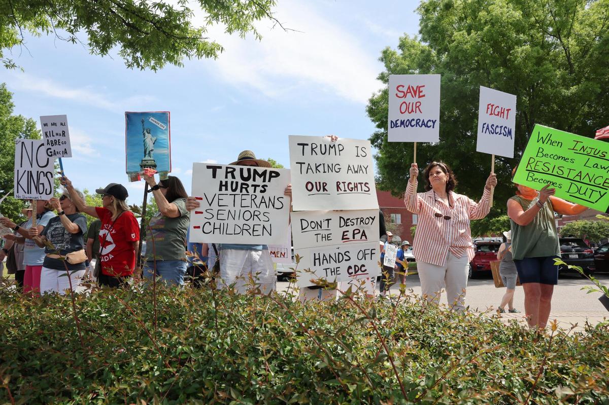 Demonstrators with York County Rising protest President Trump and his policies Sautrday in downtown Rock Hill.