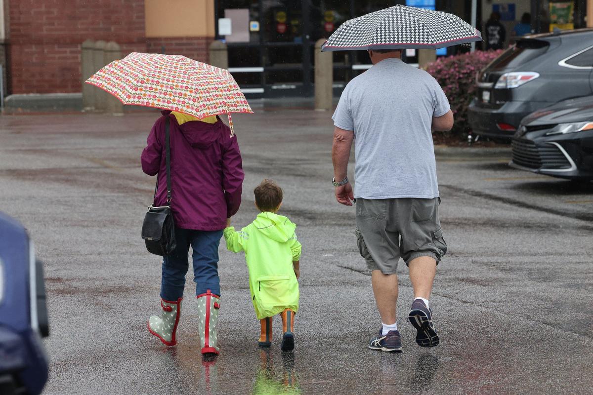 A family walked in the rain at Walmart in Rock Hill Thursday, Sept. 26, 2024.