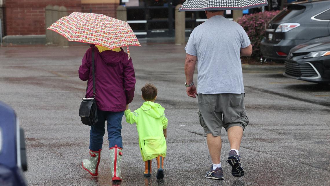 A family walks in the rain at Walmart in Rock Hill on Thursday.