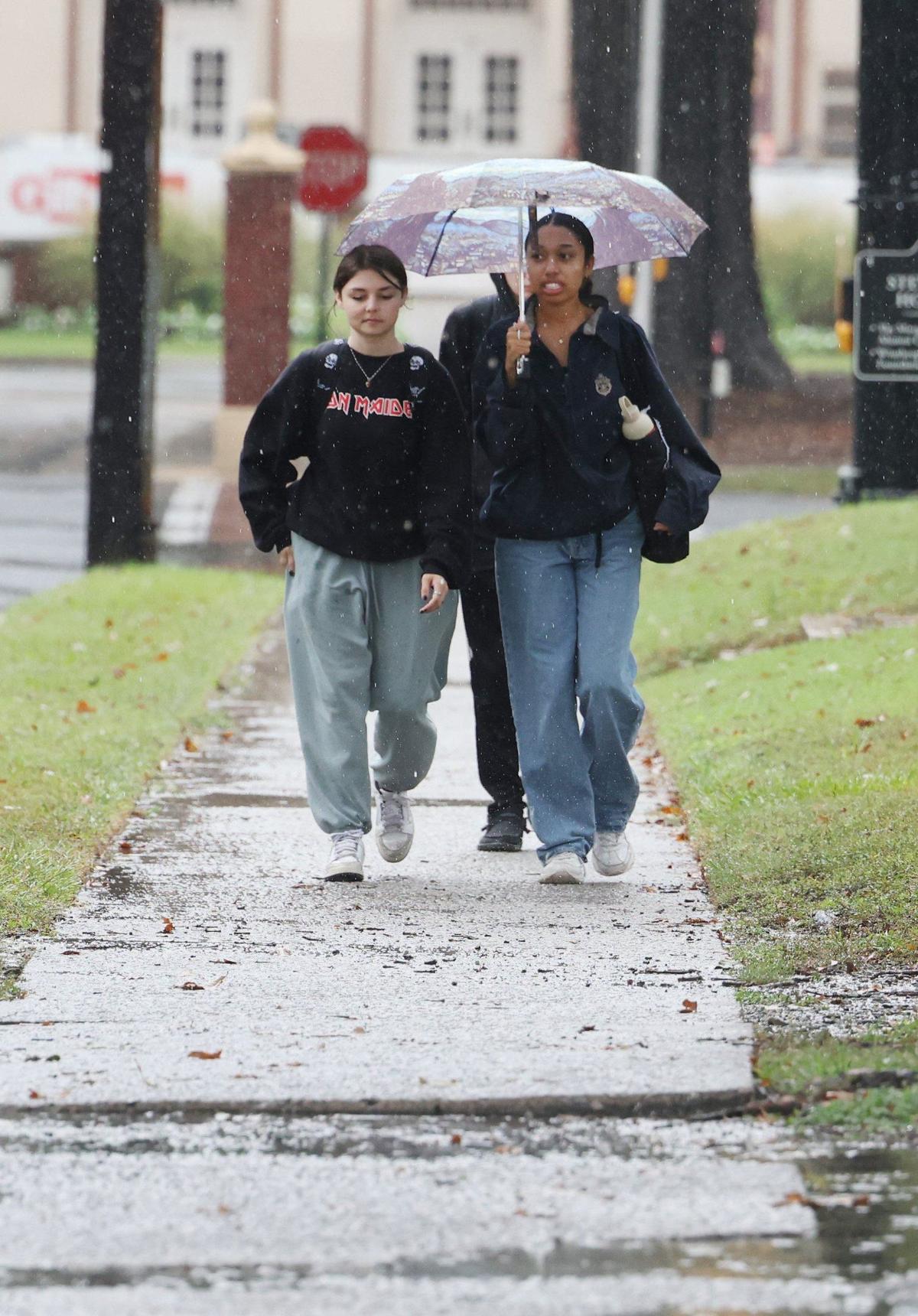 Haley Kivett, left, and Lauren Johnson walked in the rain at Winthrop University in Rock Hill on Thursday, Sept. 26, 2024.