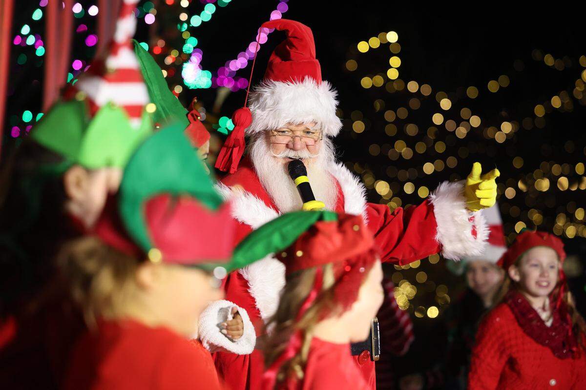 Santa Claus sings with children Thursday at the annual ChristmasVille open ceremony in downtown Rock Hill.