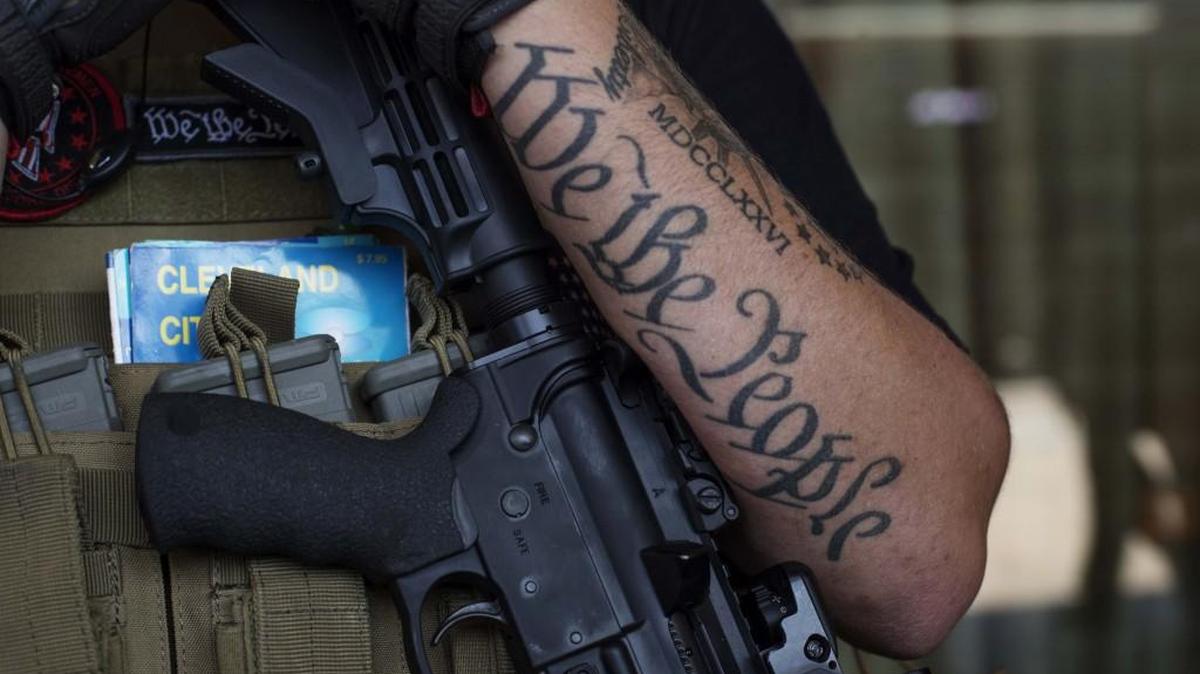 An open carry advocate holds a gun while demonstrating near the Public Square during the Republican National Convention in Cleveland on Tuesday.