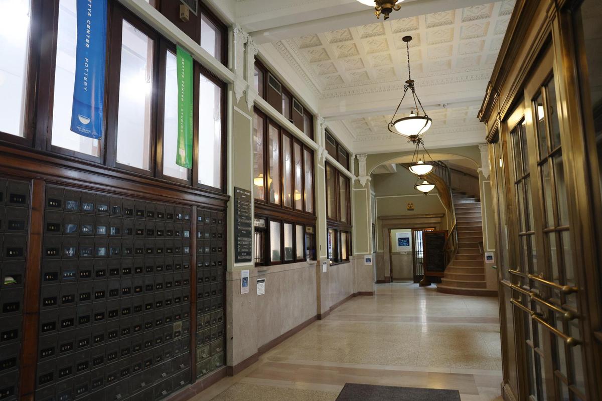 The foyer of the Tom S. Gettys center is lined with post office boxes and old light fixtures hang from the ceiling.