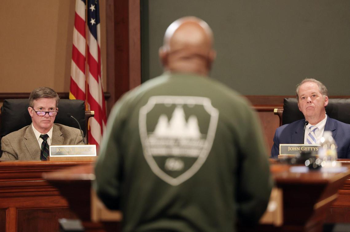 Rock Hill City Councilman John Black, left, and Mayor John Gettys listen to a speaker at a city council meeting Monday in Rock Hill.