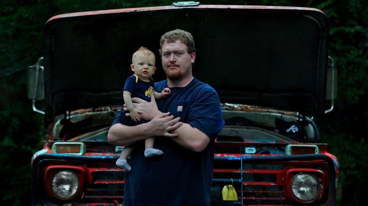 James Deshler, with his 9-month-old son, James IV, struggles to make ends meet as a worker at Golden Dragon Precise Copper Tube Group.