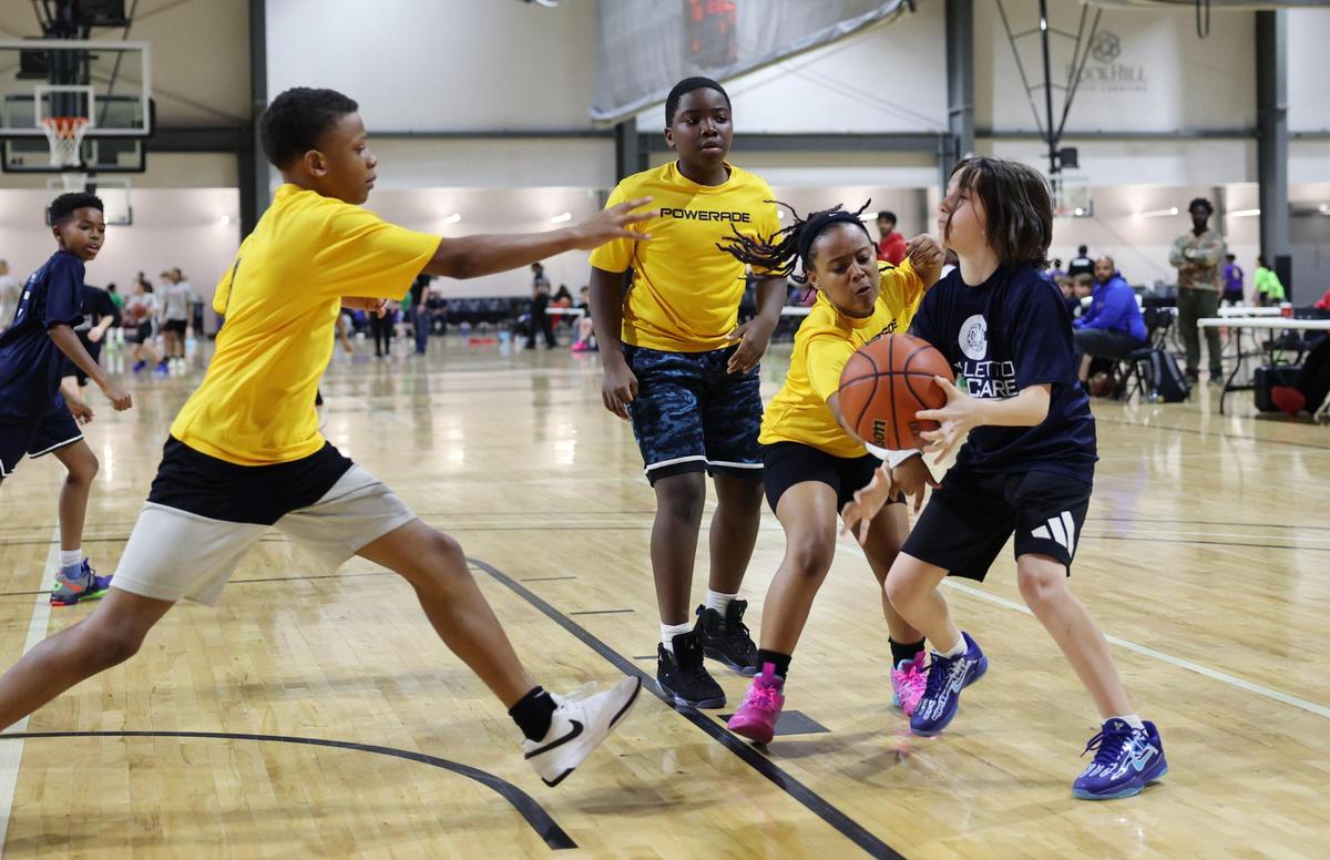 Children play basketball Wednesday at a City of Rock Hill Parks, Recreation and Tourism game at the Sports and Event Center.