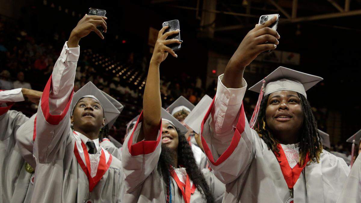South Pointe High School graduates take selfies at the close of commencement this spring at the Winthrop Coliseum. The Rock Hill School District set a policy last year that other districts will see this coming year, limiting cell phones during the school day.