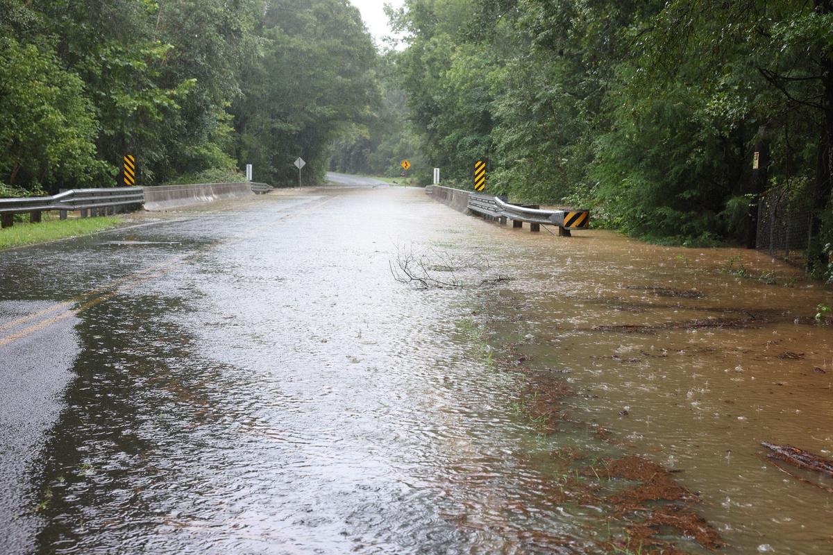 A road is covered with water after Taylor Creek overflowed its banks Thursday on Craig Road in Rock Hill, S.C. during tropical storm Debby.