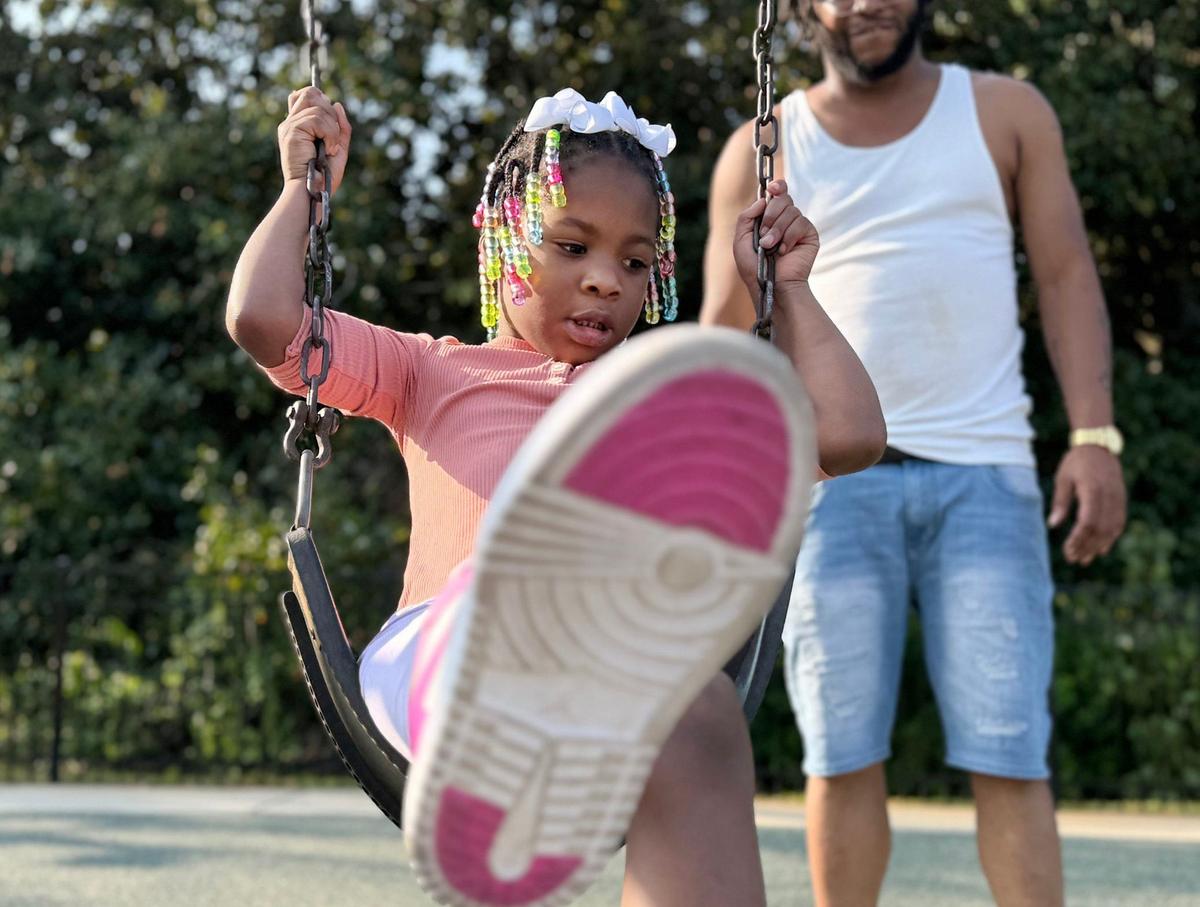 4-year-old Gianna Bowser swings with her dad Darius Bowser Tuesday at Miracle Park in Rock Hill.