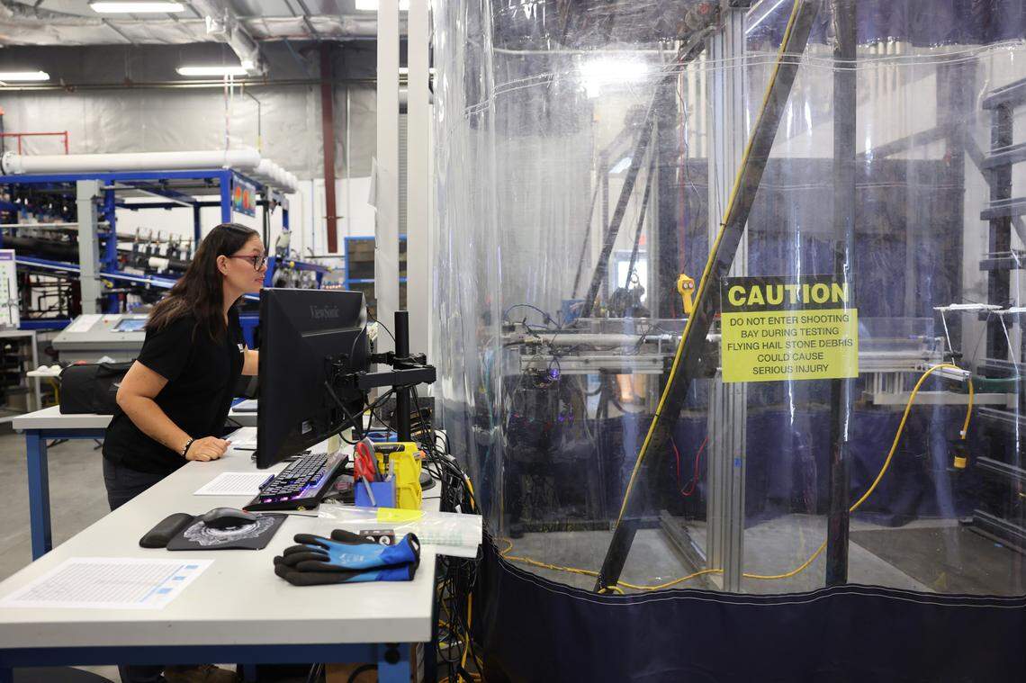 Michelle McClain of the Insurance Institute for Business and Home Safety in Richburg, S.C. sets up machinery that will blast hail at a target.