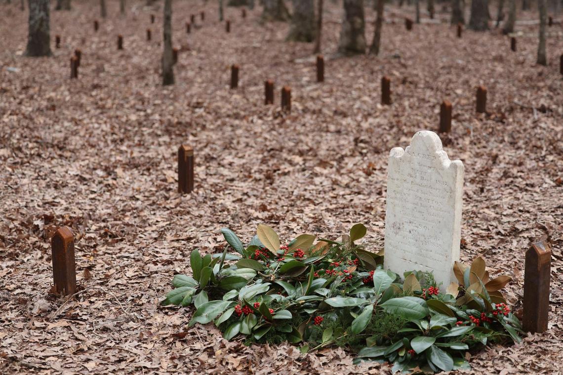 Historians at Historic Brattonsville laid a headstone dedicated to “Watt,” an enslaved man, back to its original location at a cemetery near the Revolutionary-era plantation. Small markers were placed at the sites of graves.