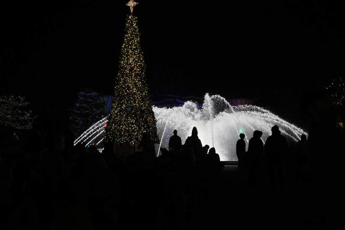People gather at Fountain Park Thursday in downtown Rock Hill for the opening ceremony of ChristmasVille